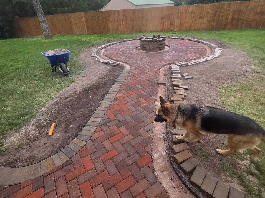 Sweeping brick border between lawn and patio