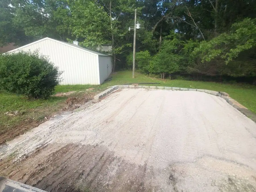 Finished driveway run alongside a lawn