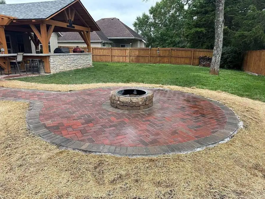 Fire pit ring set on a prepared base before the pavers go in