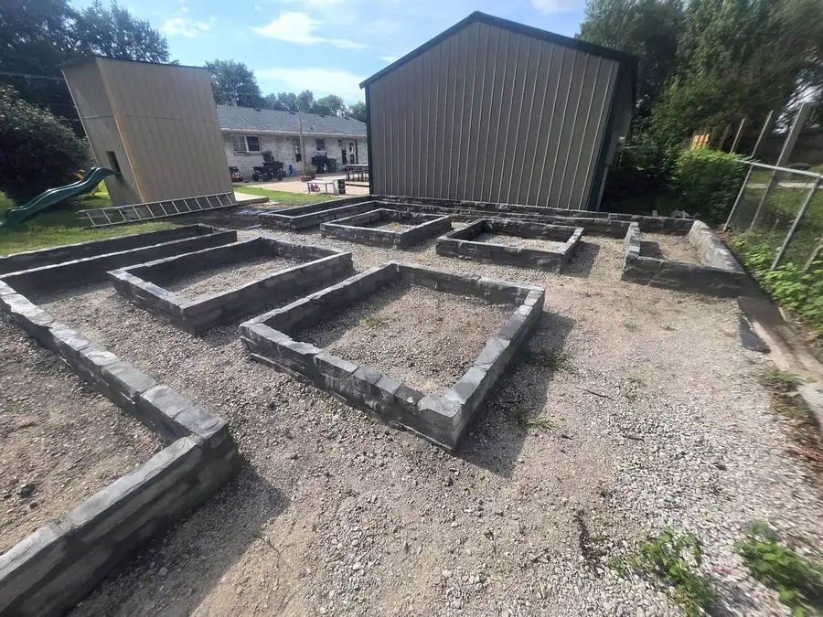 Wide view of concrete footing forms across a site