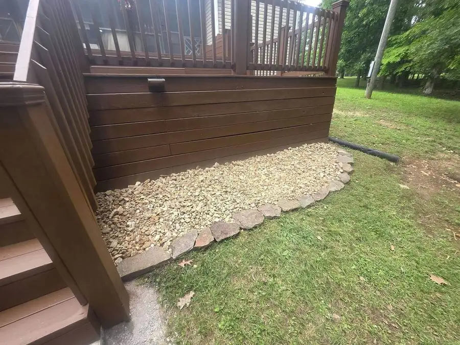 Gravel drainage bed along a deck