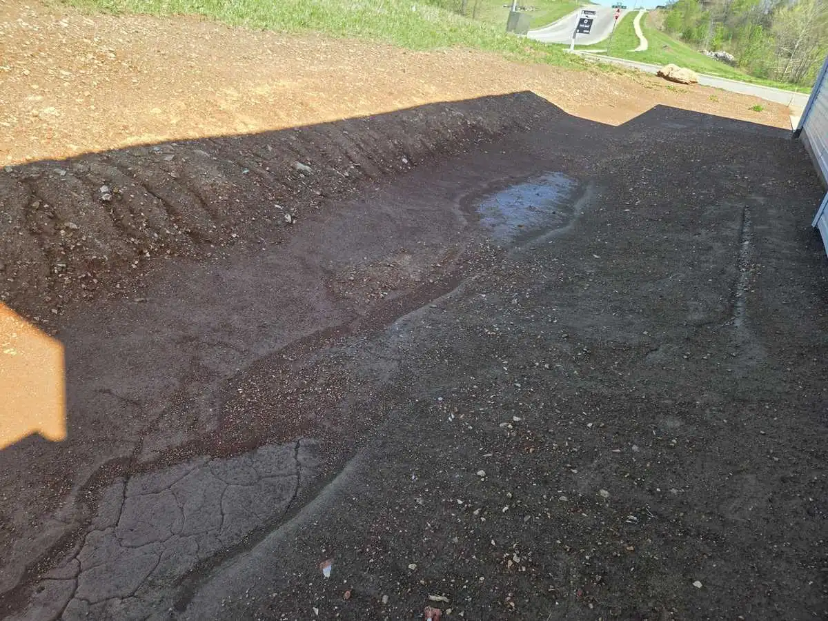 A new-construction lot rough-graded and ready for topsoil