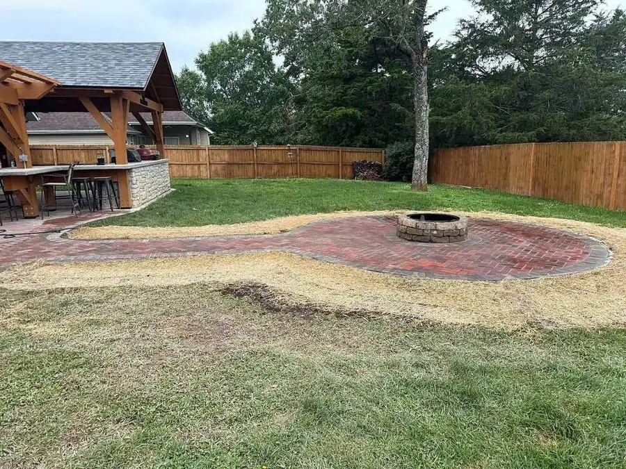 Paver field partly laid around a fire pit