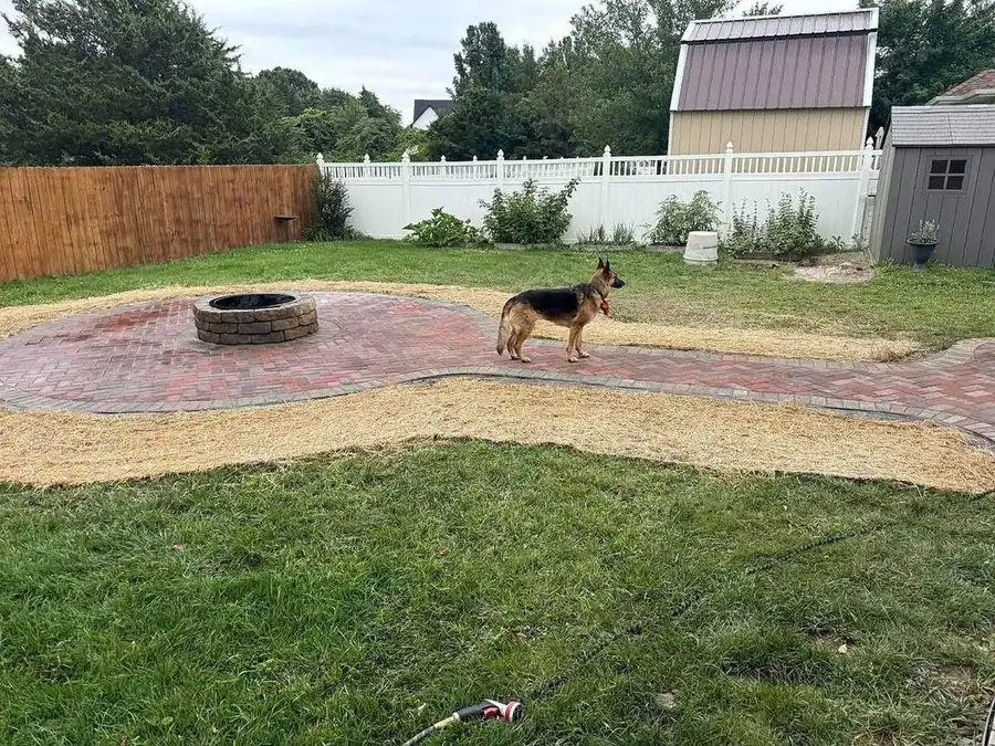 Long soldier-course border running along a brick paver patio