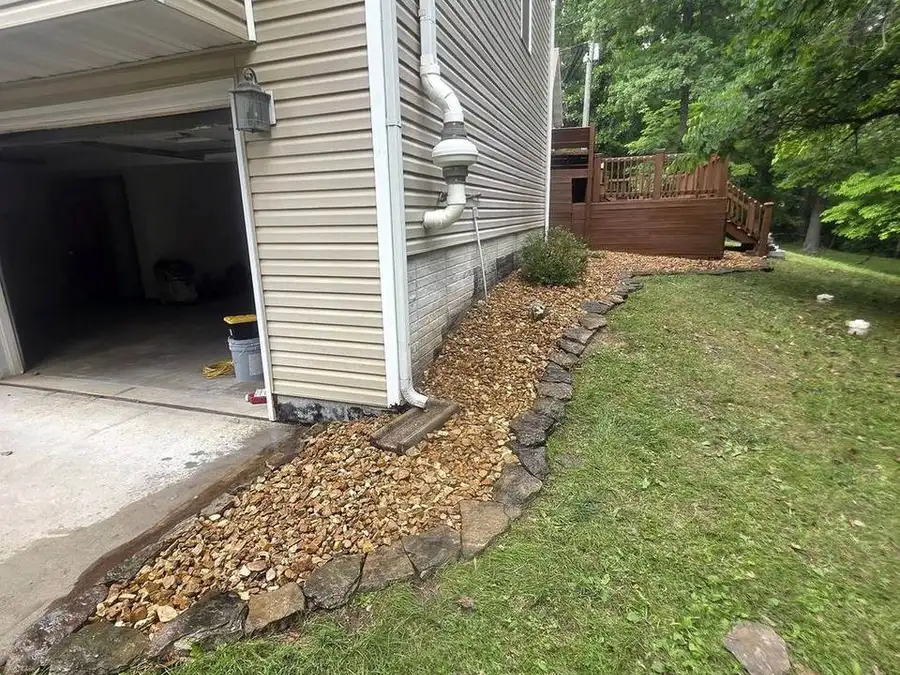 Stone edging and mulch along a house foundation