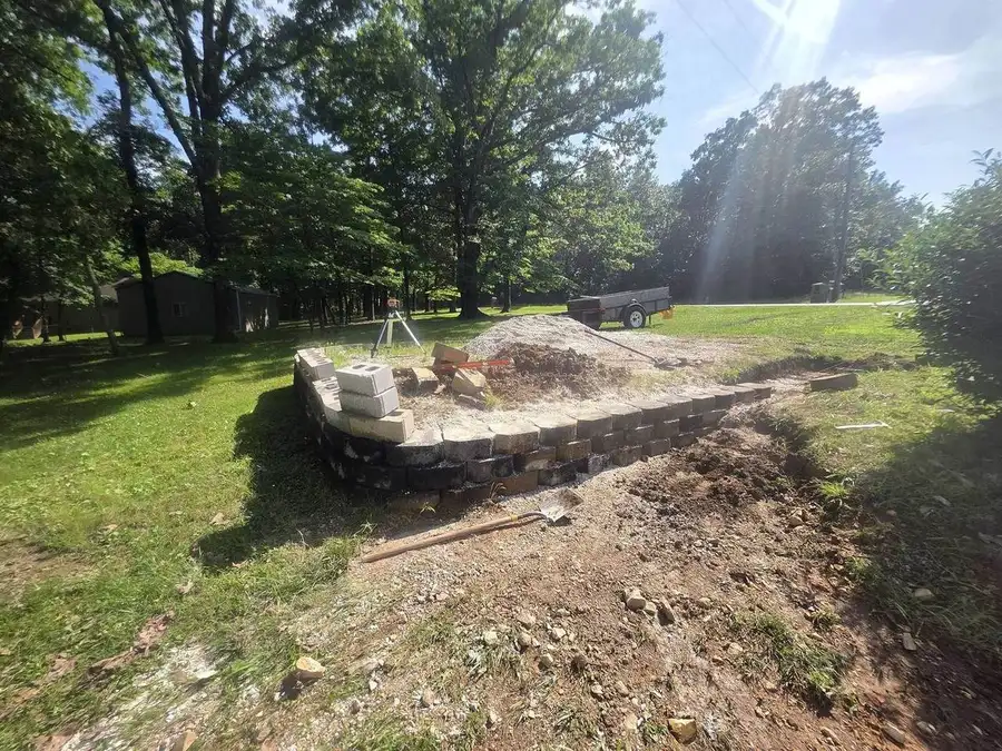 Block retaining wall holding a cut bank